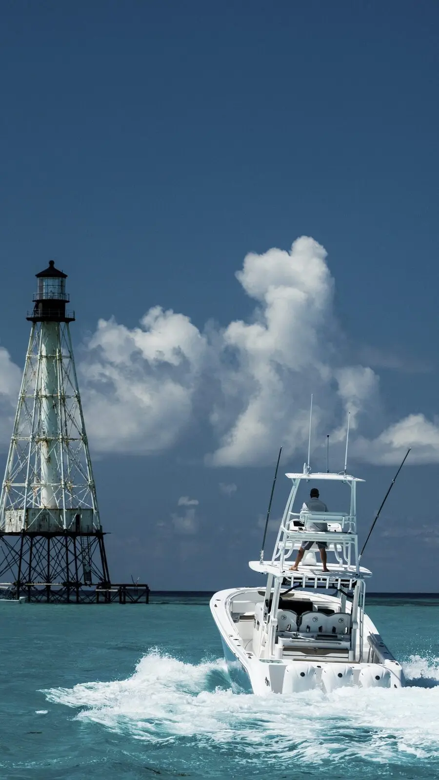 An EdgeWater center console running past an offshore lighthouse