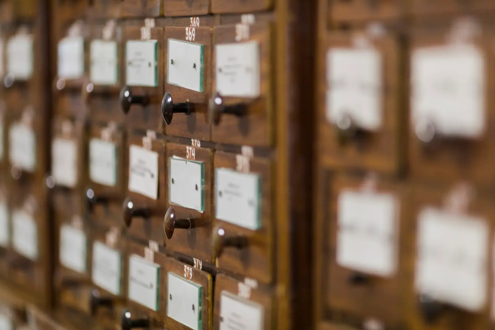 Library card catalog drawers representing how AI search engines index and retrieve business information for answer engine optimization