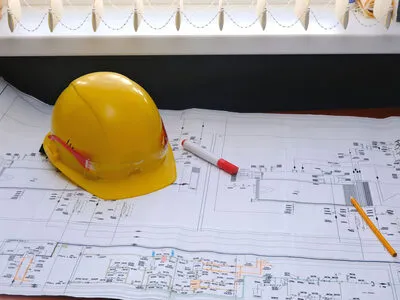 Hard hat and blueprints representing construction technology