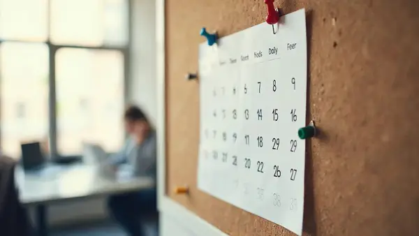 Wall calendar with pins marking the first 30 days of a fractional CTO engagement