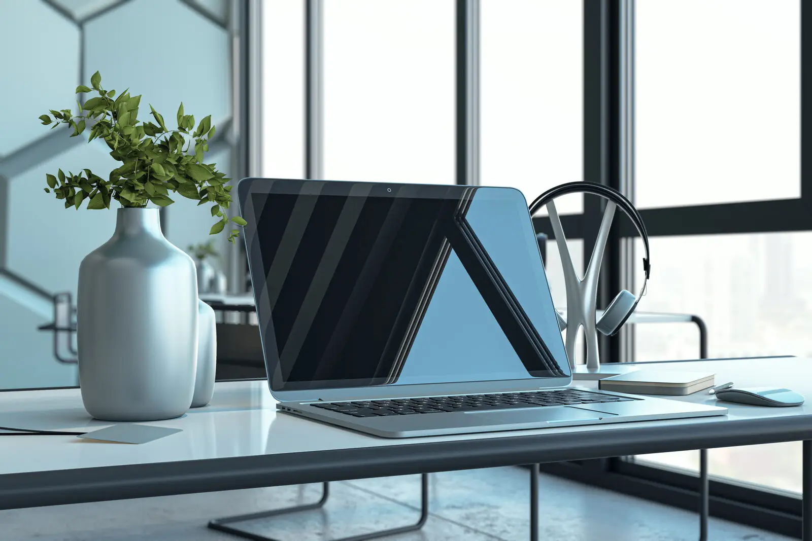 Creative technology workspace with laptop and design tools representing fractional CTO audit phase