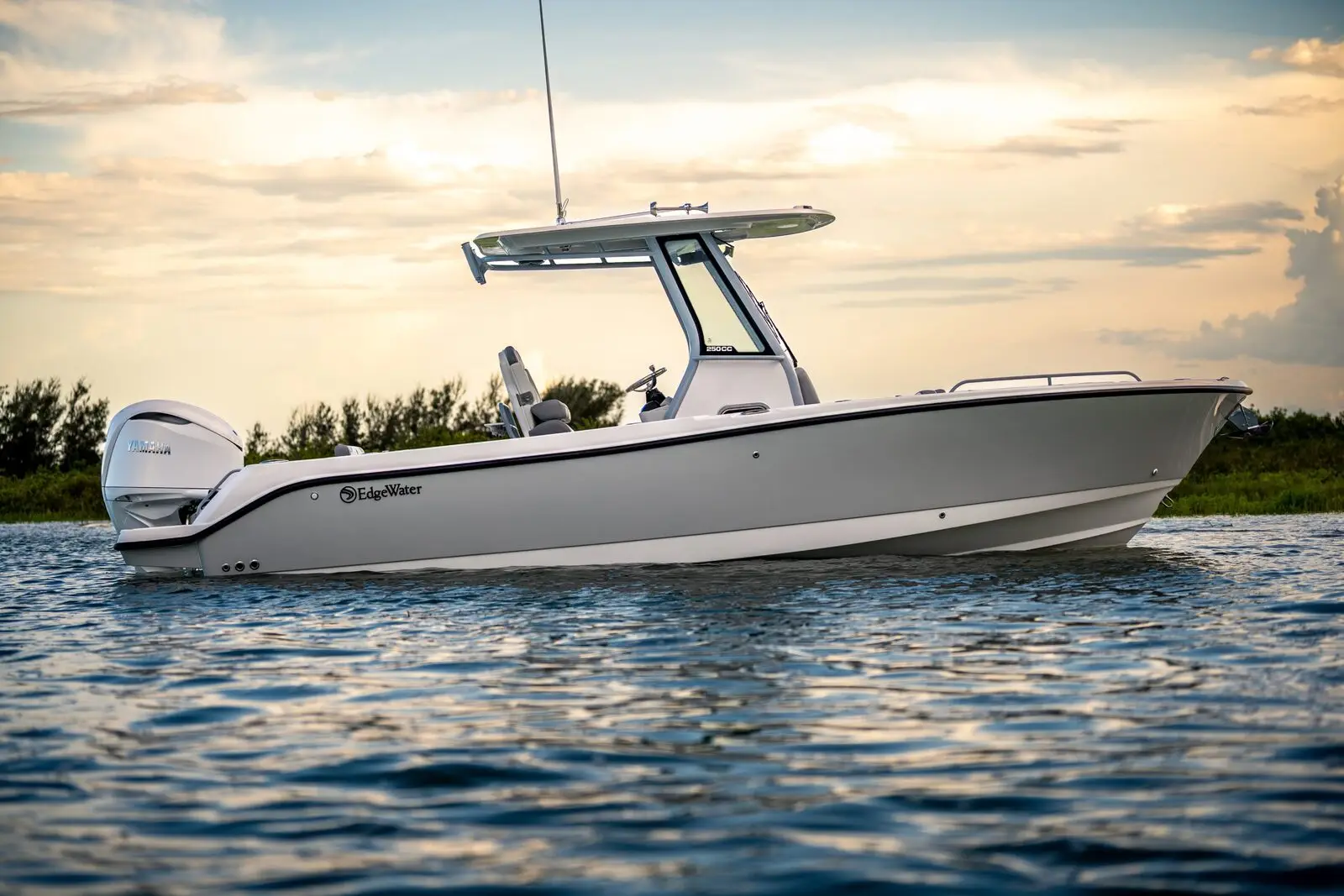 An EdgeWater 250CC center console with a single outboard, moored at sunset
