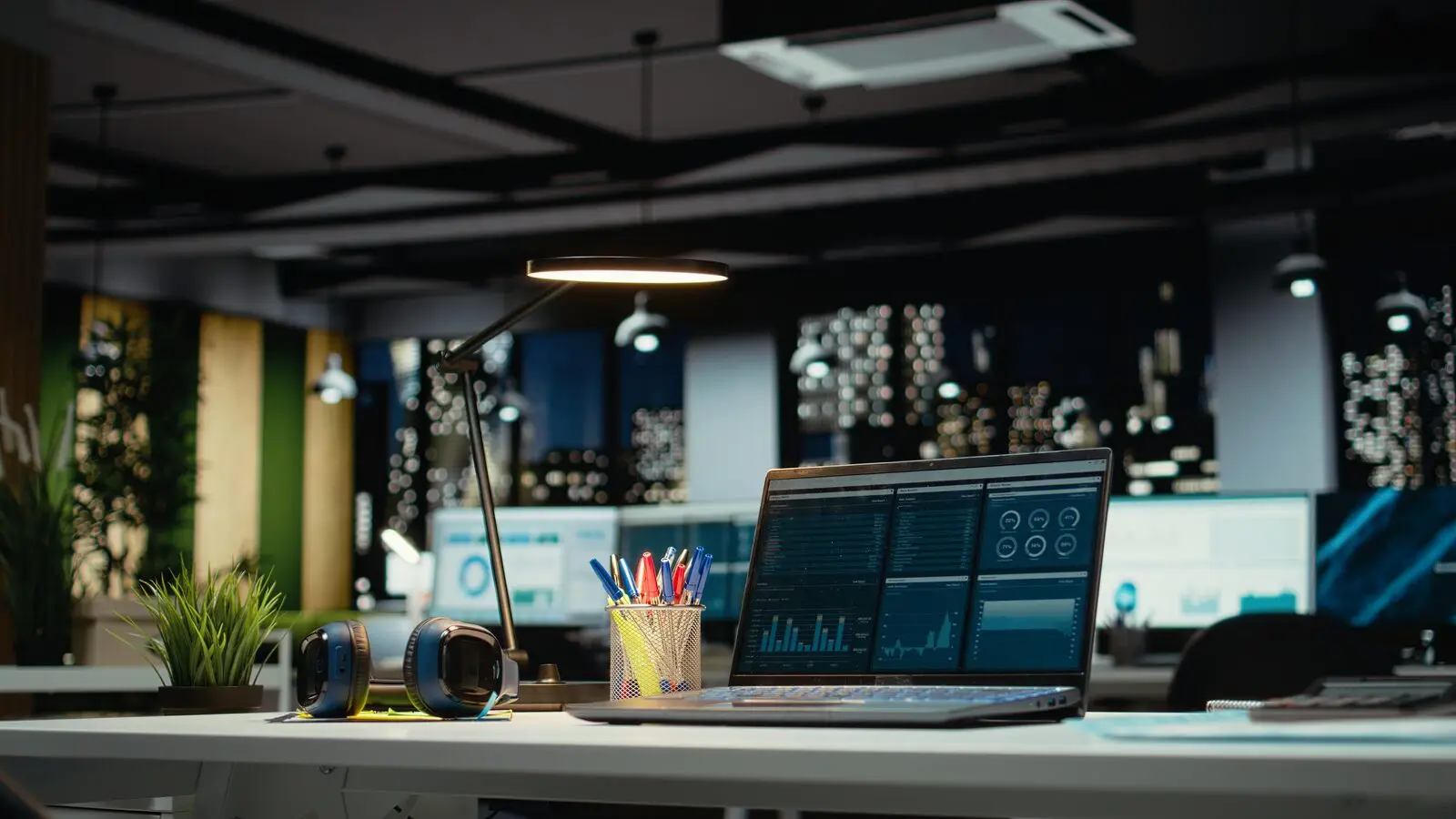 Modern office desk with laptop and reports representing a fractional CTO work environment