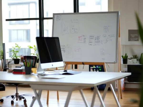 Modern office workspace with technology strategy whiteboard and desktop computer for fractional CTO planning