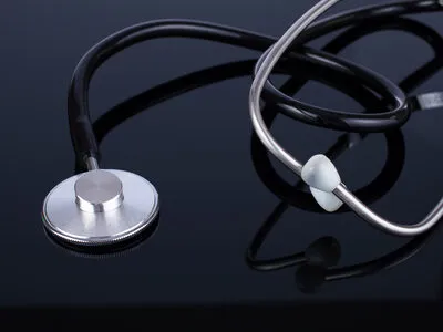 Stethoscope on dark surface representing healthcare technology