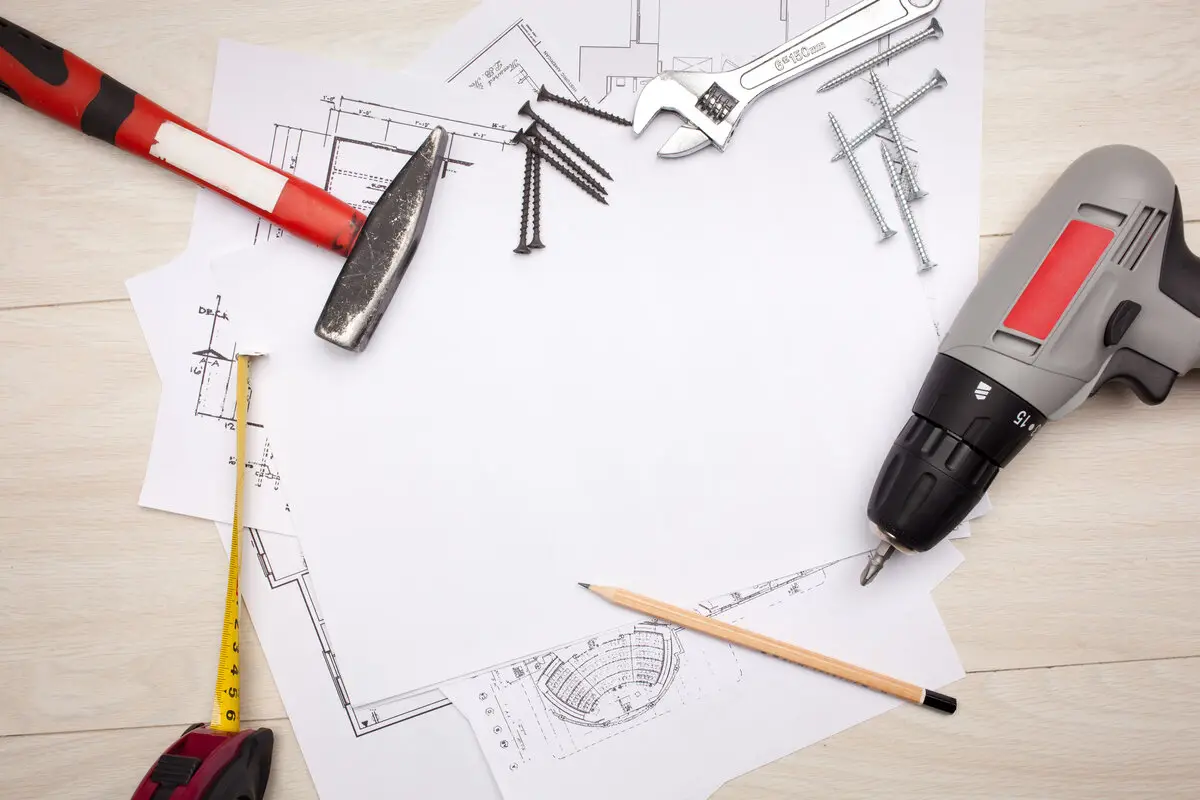 Construction blueprints and renovation tools for home services project planning and technology