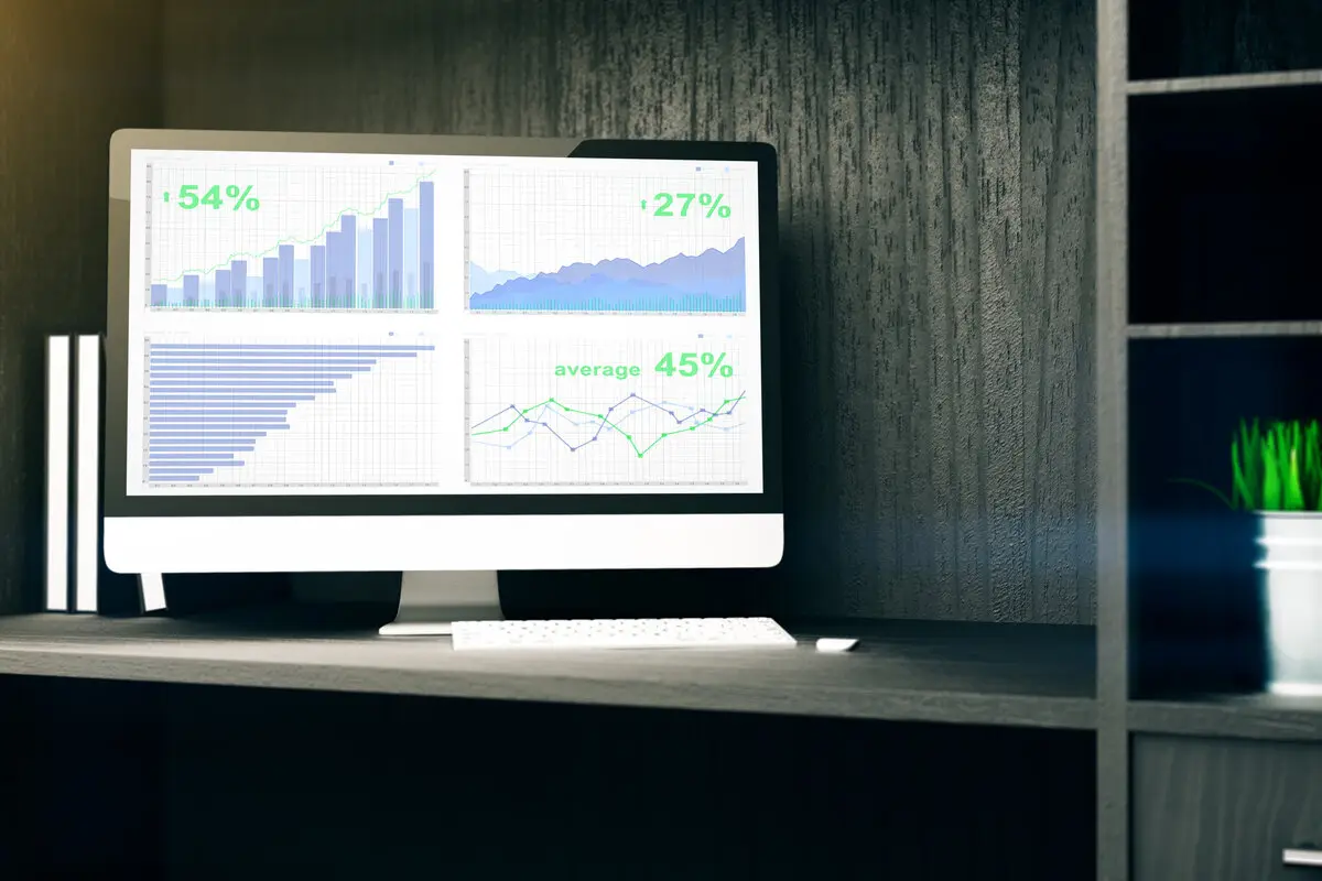 Financial analytics dashboard on computer monitor for insurance agency technology optimization