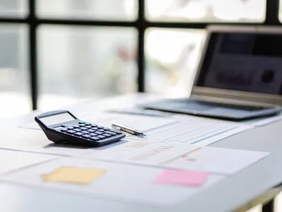 Calculator and financial documents representing insurance technology