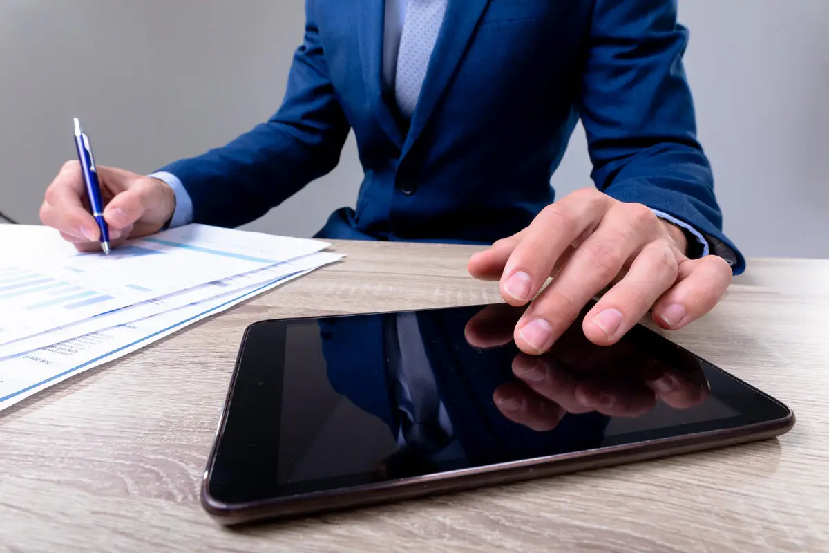 Digital tablet and legal documents on professional office desk for law firm technology integration