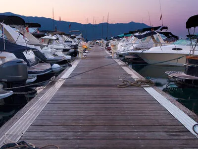 Boats moored at harbor representing marine industry technology