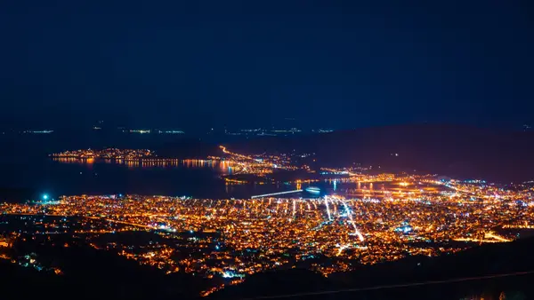 A city of lights seen from above at night, representing a business visible across many places online rather than in one