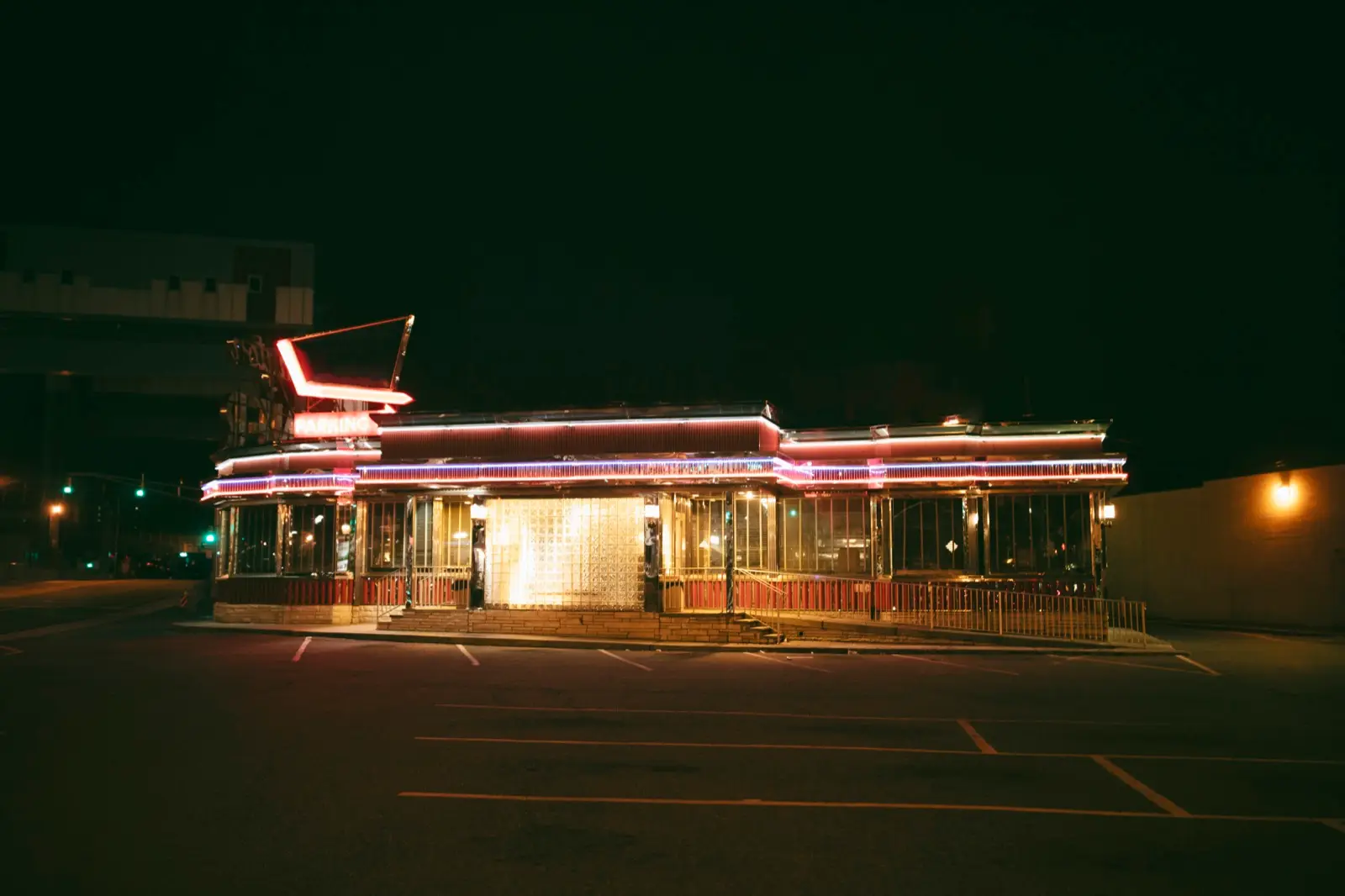 A single lit storefront on a dark city street at night, representing a website with no web presence around it