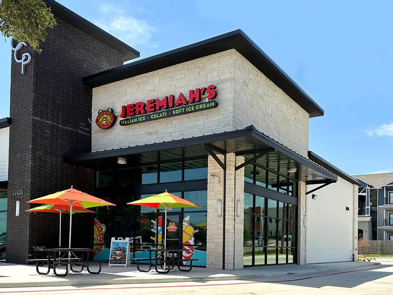 Jeremiah's Italian Ice storefront at night with illuminated signage, a Jeremy Buff client