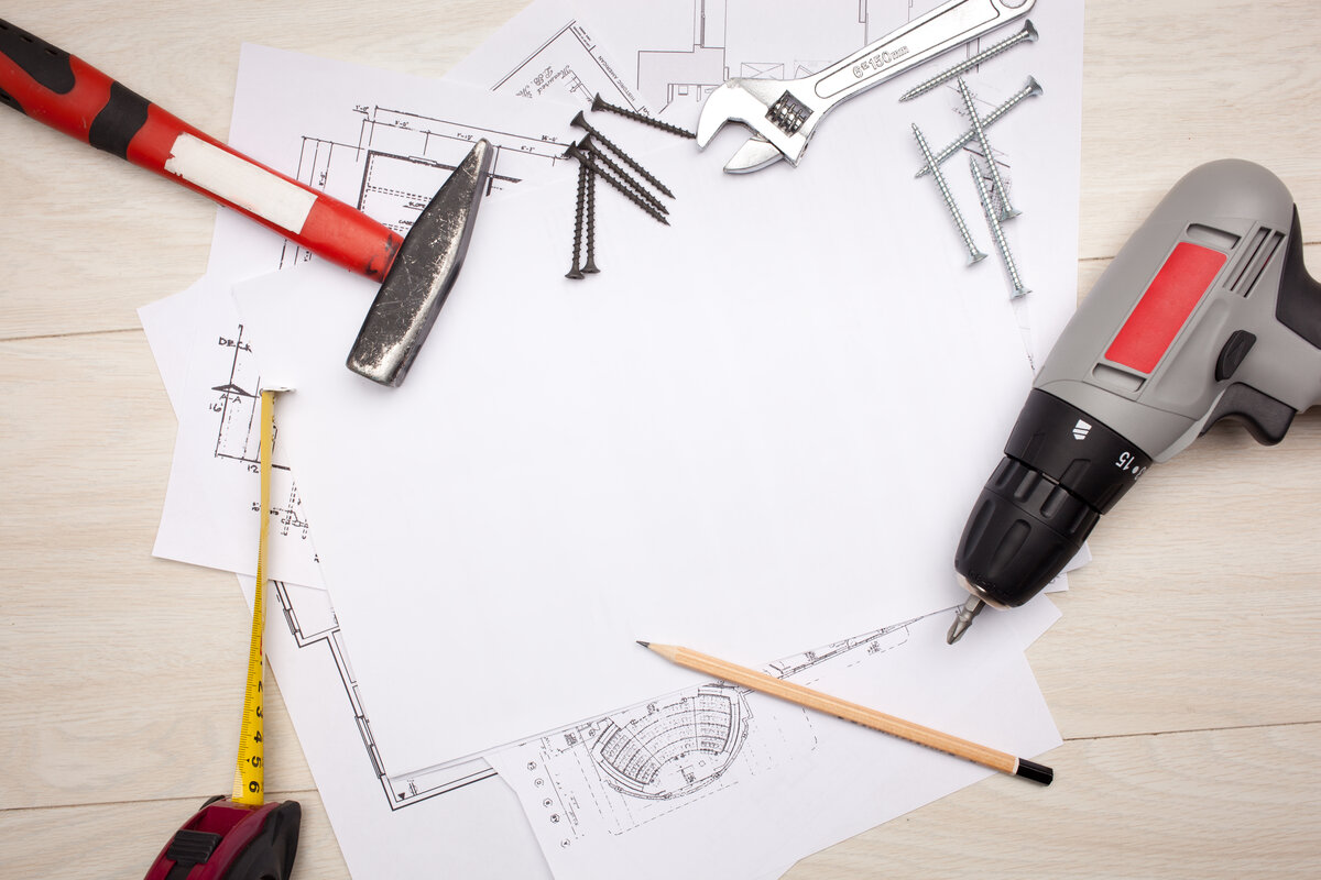 Construction blueprints and renovation tools for home services project planning and technology