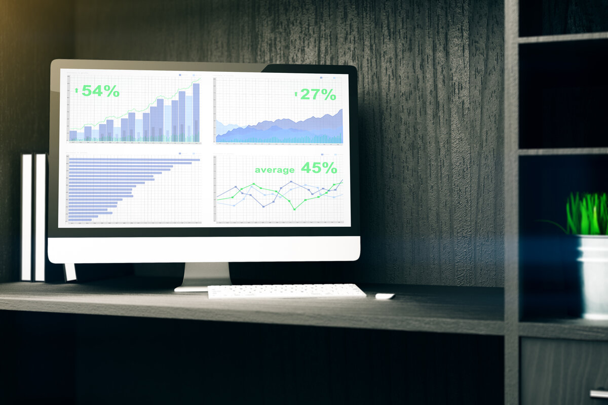 Financial analytics dashboard on computer monitor for insurance agency technology optimization