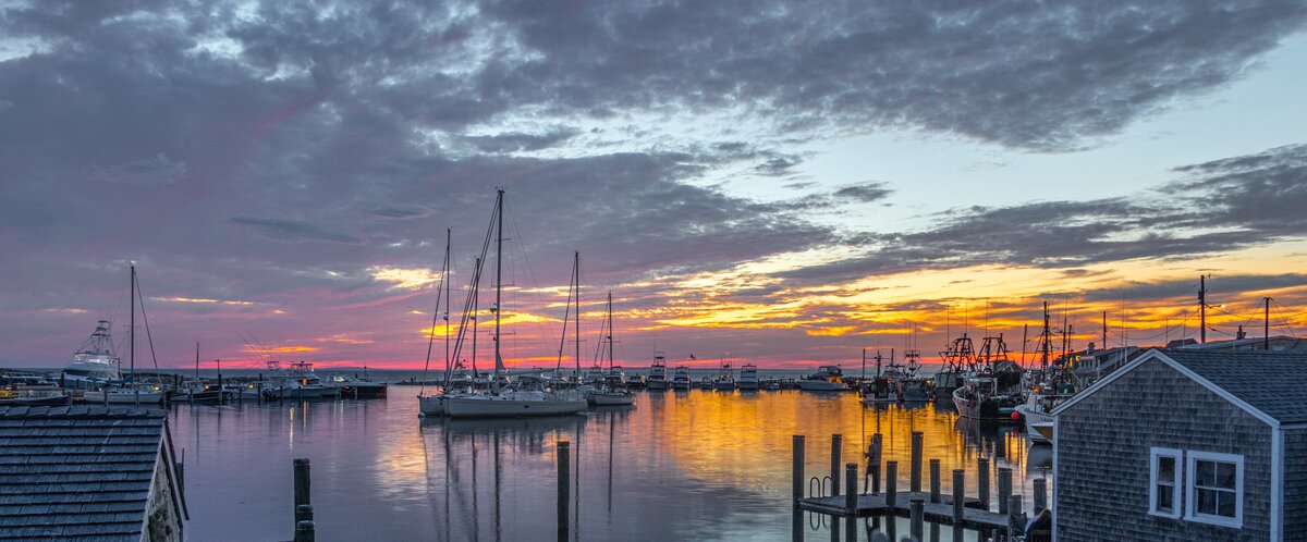 Panoramic marina sunset with sailboats representing coastal marine business technology solutions