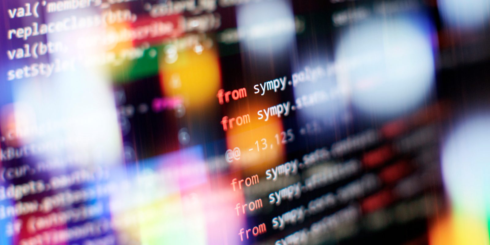 Abstract software source code on screen representing build vs buy technology decisions