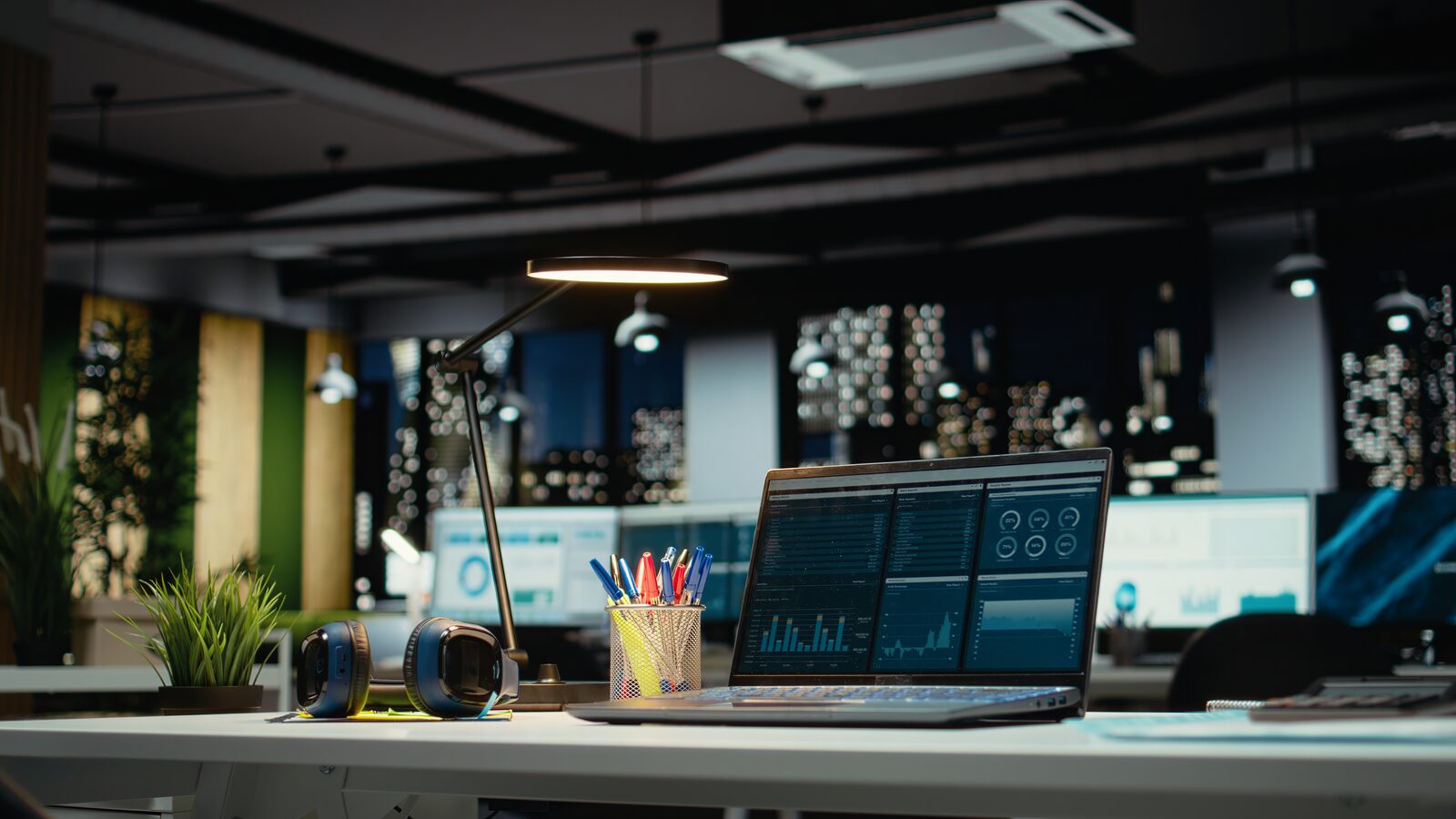 Modern office desk with laptop and reports representing a fractional CTO work environment